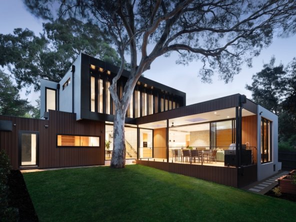 brown and white wooden house near green trees during daytime